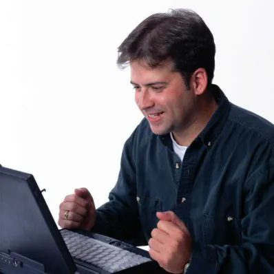a man is using a laptop computer .png