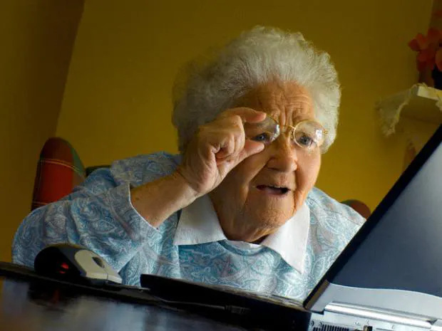 a woman sitting in front of a laptop computer .png