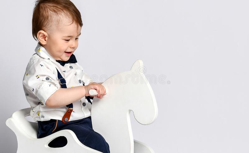 00750075---funny-baby-sitting-toy-horse-white-studio-background-174884824.jpg